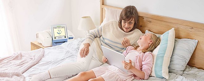 Peritoneal dialysis - woman with child lying in bed