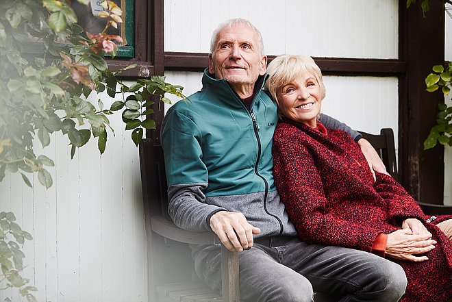 elderly people sitting on a bench
