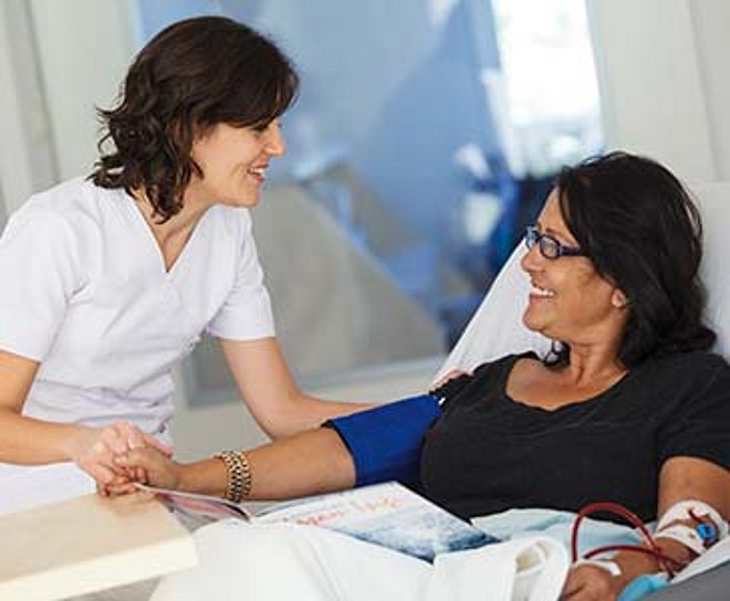 Nurse attending patient in bed