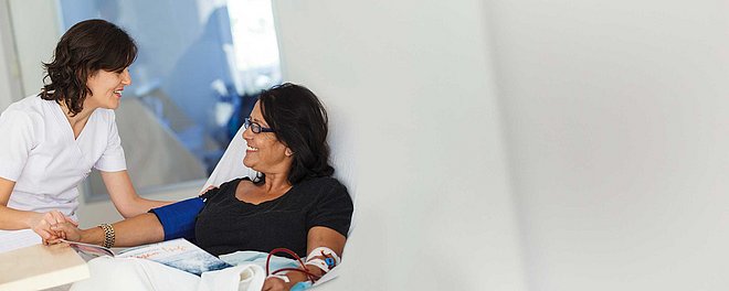 Nurse attending patient in bed