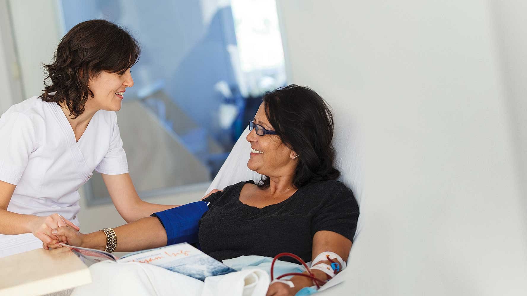 Nurse attending patient in bed