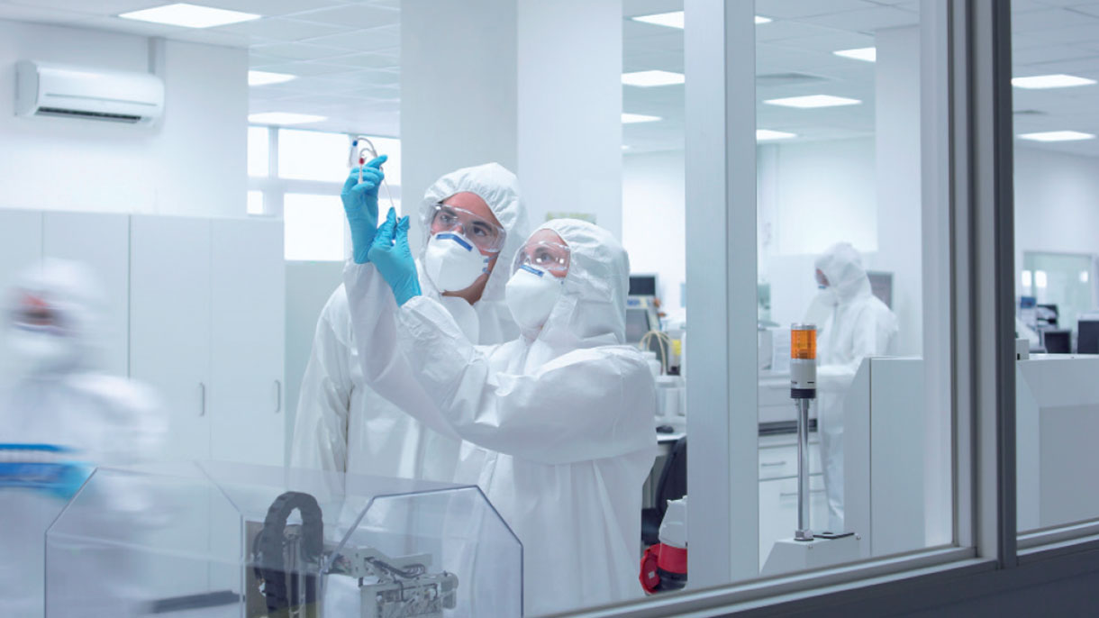 Laboratory technicians examining sample Laboratory technicians examining sample